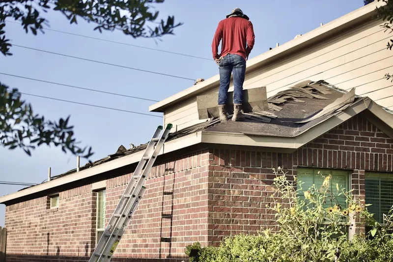 Professional roofer working on a residential roof in Trentwood